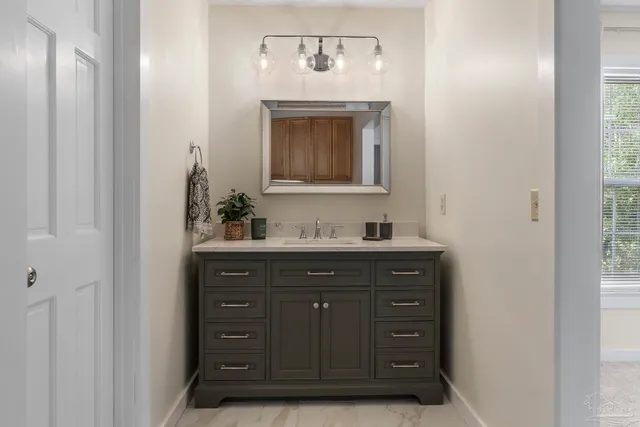 a bathroom with a sink and a mirror