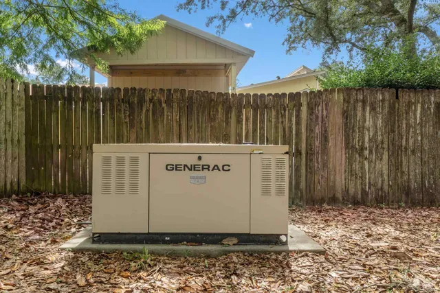 a black white building with wooden fence