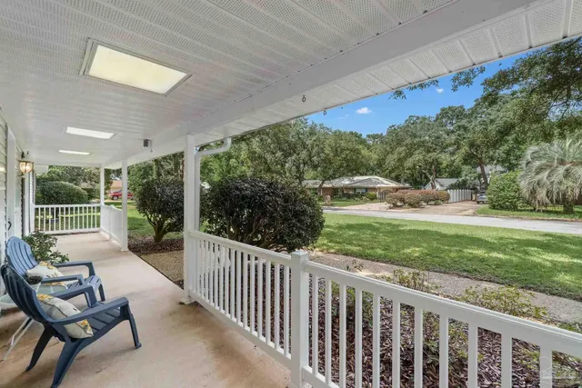 a view of a porch with furniture and garden