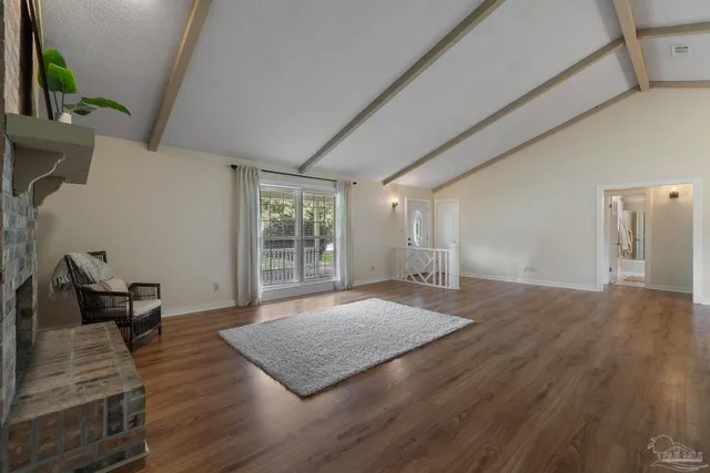 a view of an empty room and wooden floor