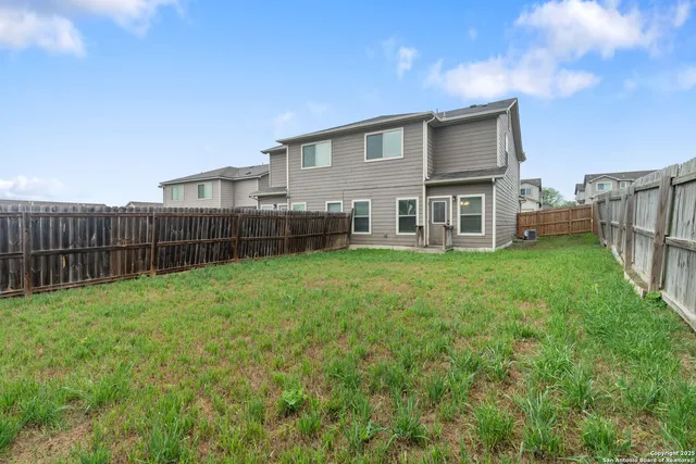 a view of a house with a yard and sitting area