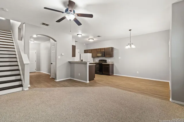 a view of a kitchen with a sink and a ceiling fan