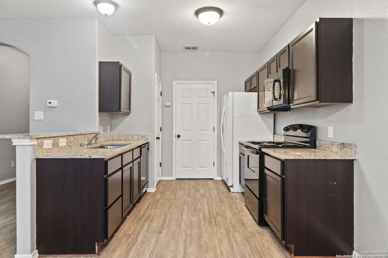 8707 Azul Sky Court Converse, TX 78109 - Photo 4 of 16 a kitchen with stainless steel appliances a stove and a refrigerator