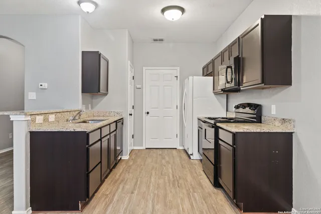 a kitchen with stainless steel appliances a stove and a refrigerator