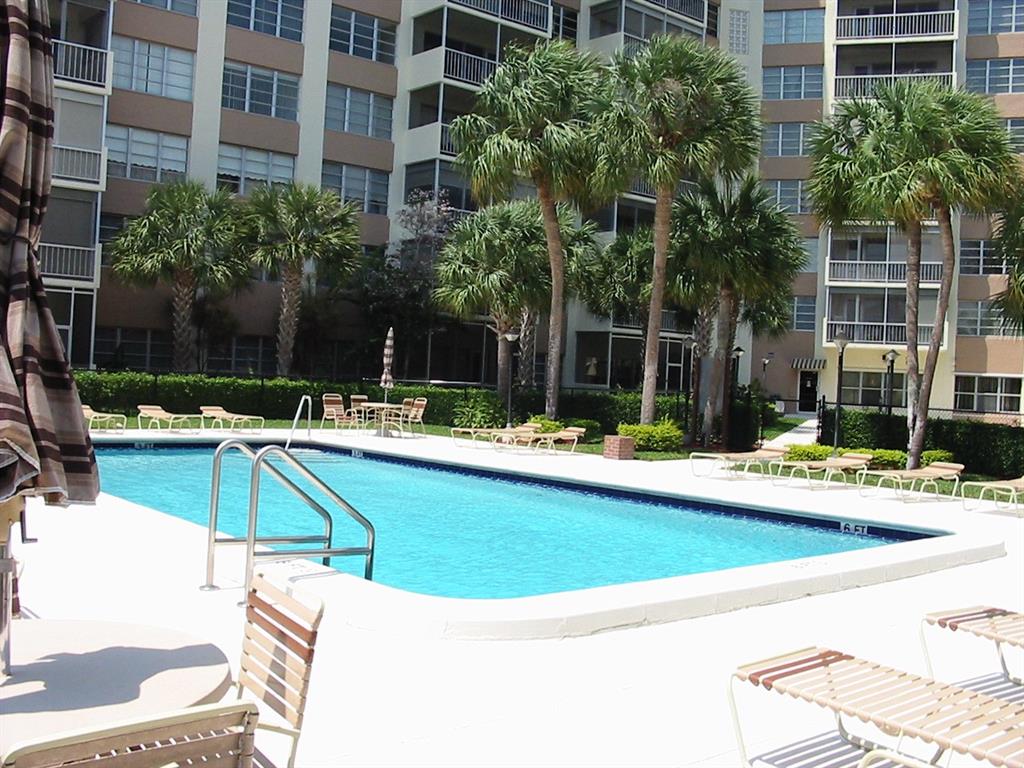 10777 West Sample Road, Unit 1104 Coral Springs, FL 33065 - Photo 14 of 25 a view of a swimming pool with a patio