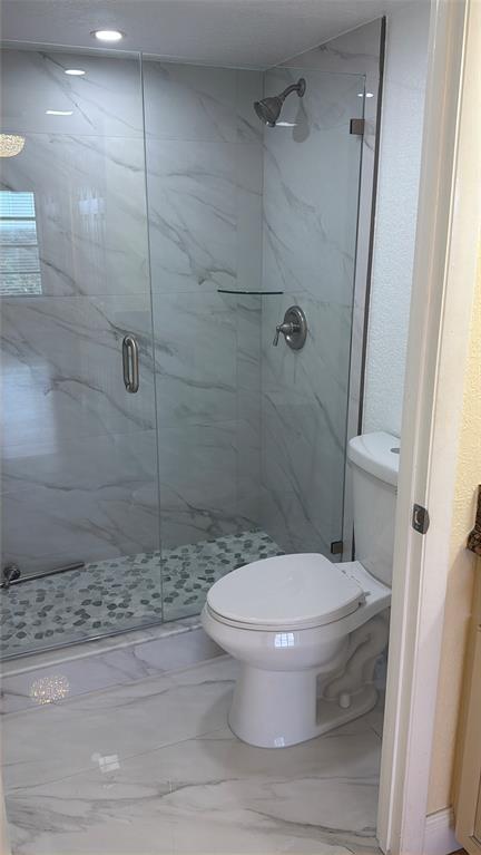 10777 West Sample Road, Unit 1104 Coral Springs, FL 33065 - Photo 21 of 25 a bathroom with a toilet and a shower