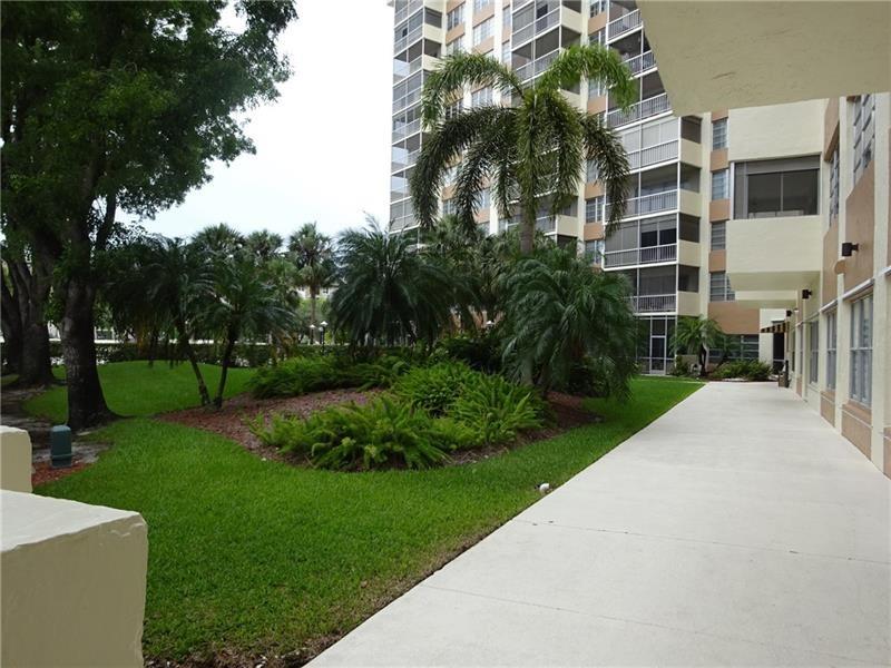 10777 West Sample Road, Unit 1104 Coral Springs, FL 33065 - Photo 4 of 25 a view of a apartment with a yard