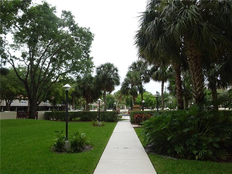10777 West Sample Road, Unit 1104 Coral Springs, FL 33065 - Photo 5 of 25 a view of park with tree s