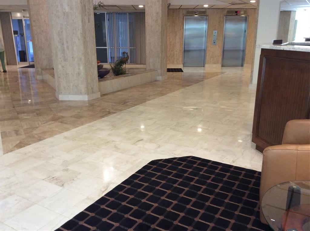 10777 West Sample Road, Unit 1104 Coral Springs, FL 33065 - Photo 7 of 25 a bedroom with a bed and a mirror