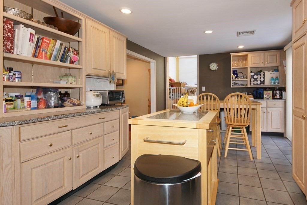 39 Locust Street Burlington, MA 01803 - Photo 19 of 27 a kitchen with stainless steel appliances granite countertop a sink and a refrigerator