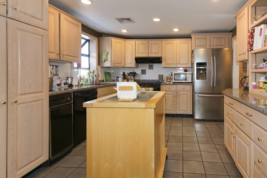 39 Locust Street Burlington, MA 01803 - Photo 20 of 27 a kitchen with a refrigerator a sink and cabinets