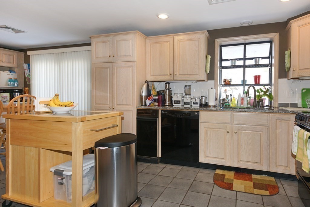 39 Locust Street Burlington, MA 01803 - Photo 21 of 27 a kitchen with a sink stove and cabinets