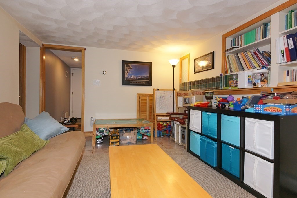 39 Locust Street Burlington, MA 01803 - Photo 6 of 27 a living room with furniture flat screen tv and a table