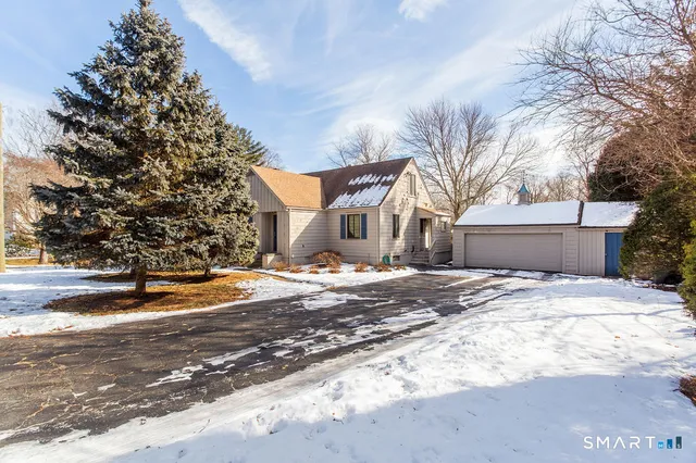 a view of a house with snow on the road