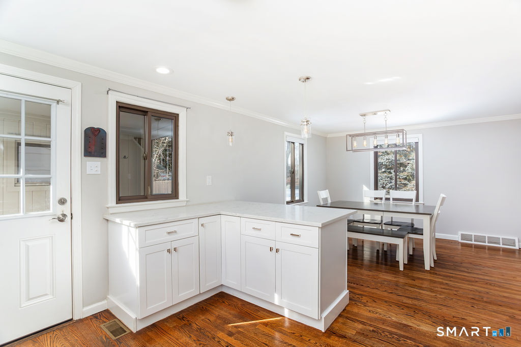 245 Reid Street Fairfield, CT 06824 - Photo 16 of 33 a kitchen with a sink cabinets and wooden floor