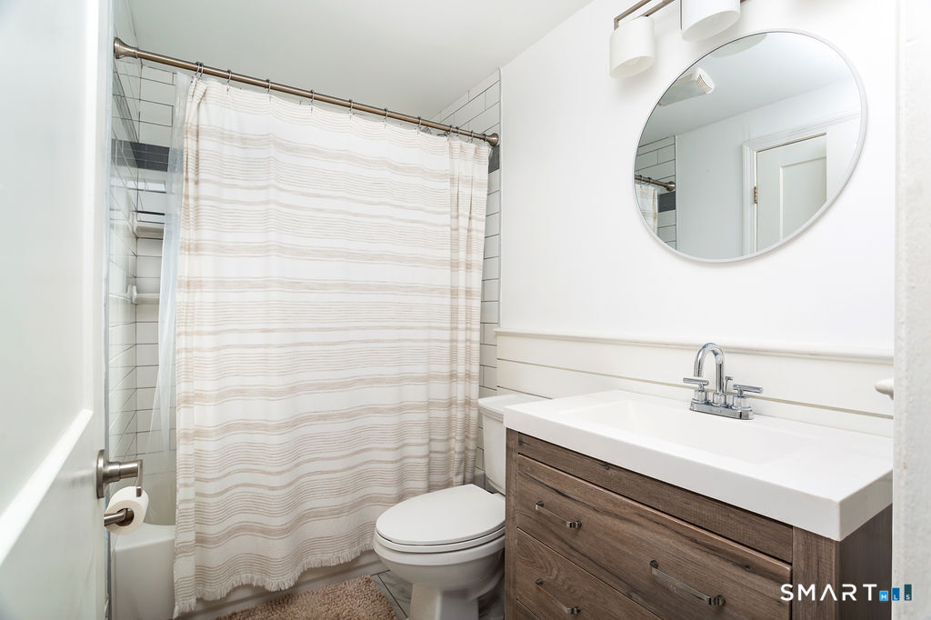 245 Reid Street Fairfield, CT 06824 - Photo 17 of 33 a bathroom with a sink toilet and mirror