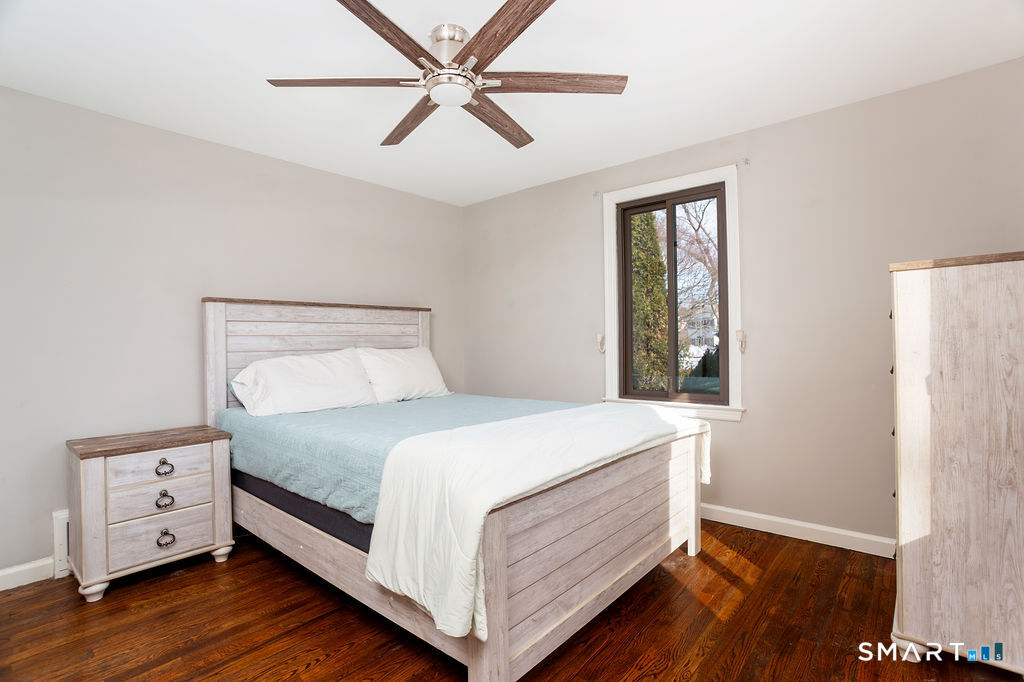 245 Reid Street Fairfield, CT 06824 - Photo 19 of 33 a bedroom with a bed and a window