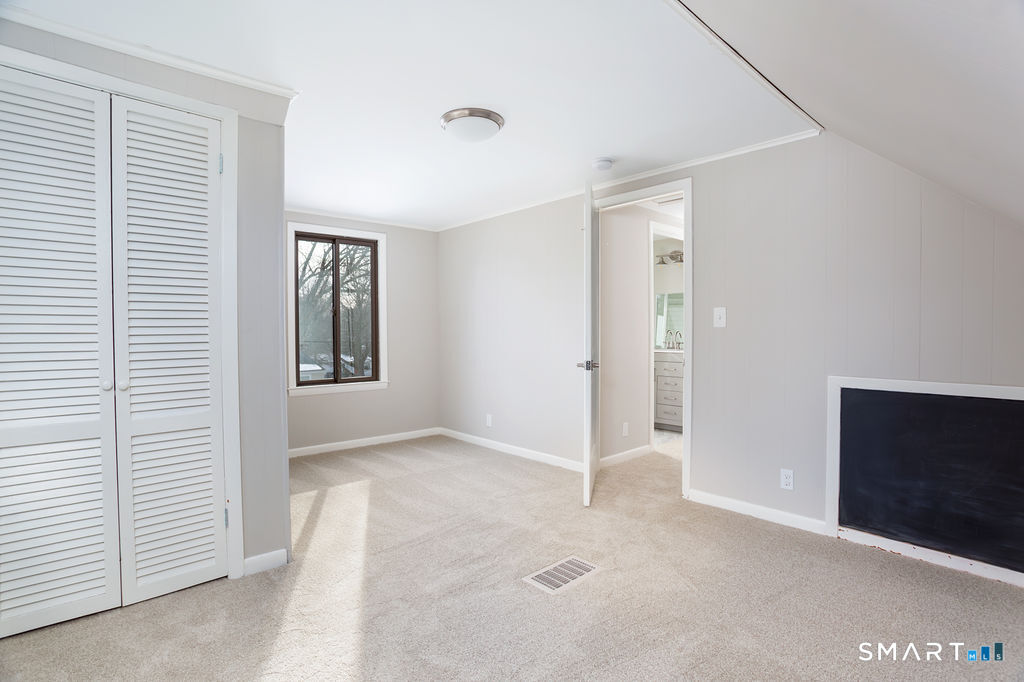 245 Reid Street Fairfield, CT 06824 - Photo 25 of 33 a view of an empty room with closet and a window