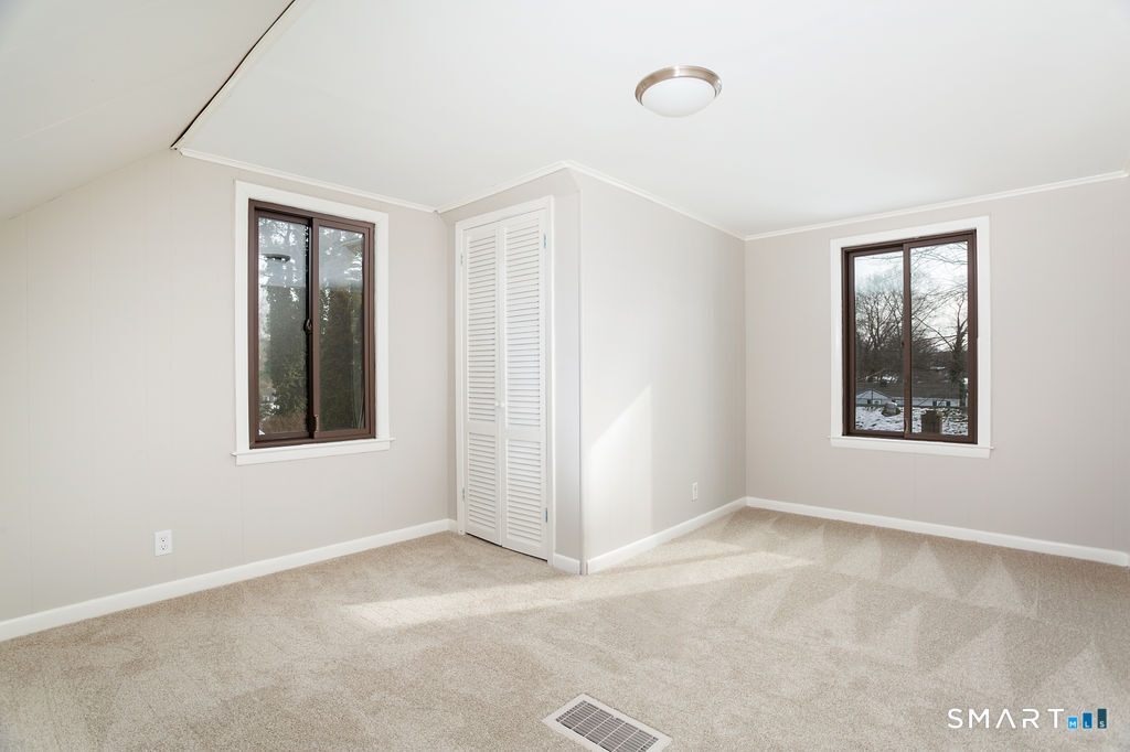 245 Reid Street Fairfield, CT 06824 - Photo 26 of 33 an empty room with windows and closet