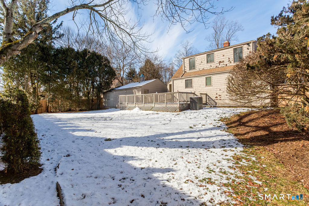 245 Reid Street Fairfield, CT 06824 - Photo 27 of 33 a view of white house with a yard covered in snow