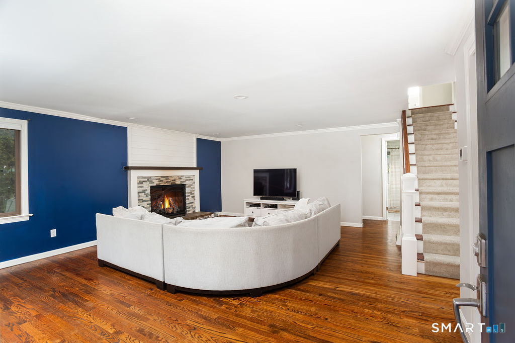 245 Reid Street Fairfield, CT 06824 - Photo 3 of 33 a living room with furniture and a flat screen tv