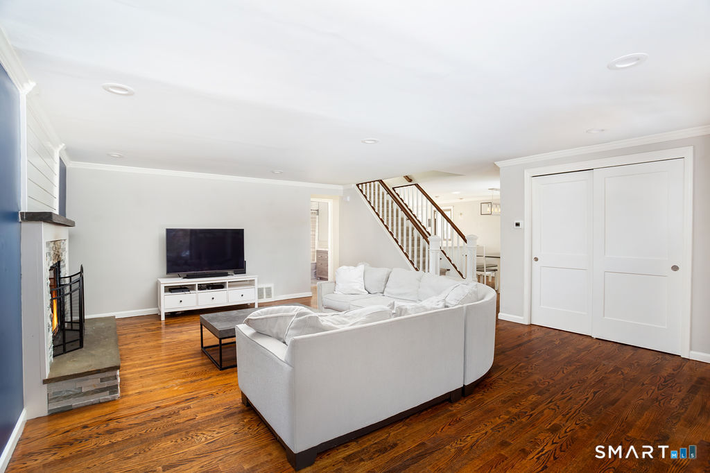 245 Reid Street Fairfield, CT 06824 - Photo 4 of 33 a living room with furniture and a flat screen tv