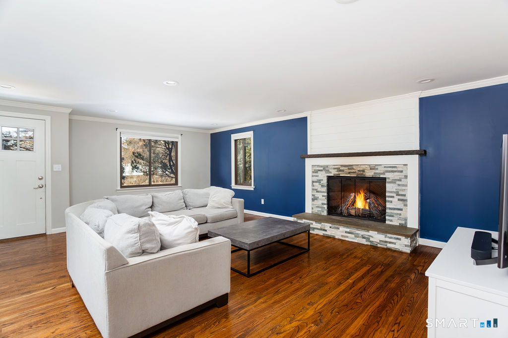 245 Reid Street Fairfield, CT 06824 - Photo 6 of 33 a living room with furniture and a fireplace