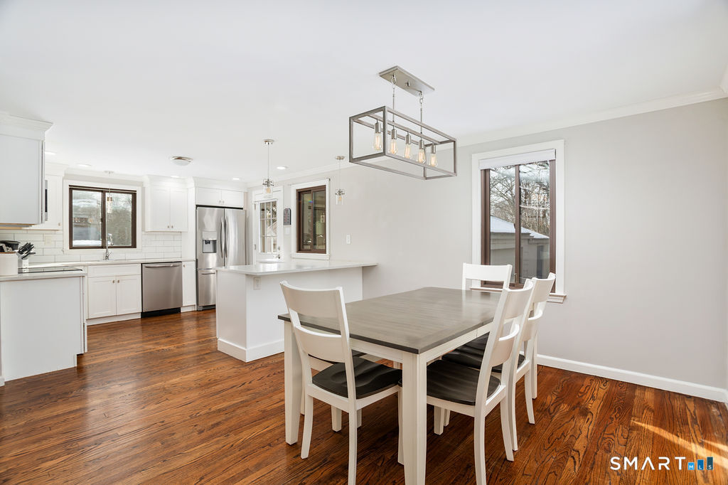 245 Reid Street Fairfield, CT 06824 - Photo 8 of 33 a view of a dining room with furniture and wooden floor