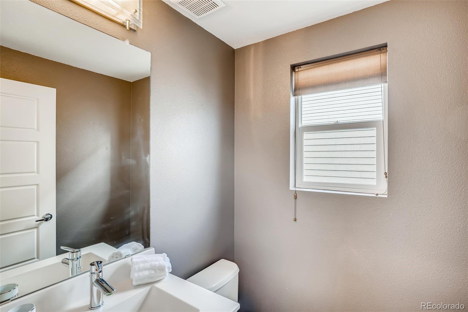9817 Dunning Circle Highlands Ranch, CO 80126 - Photo 13 of 28 a bathroom with a toilet and a sink