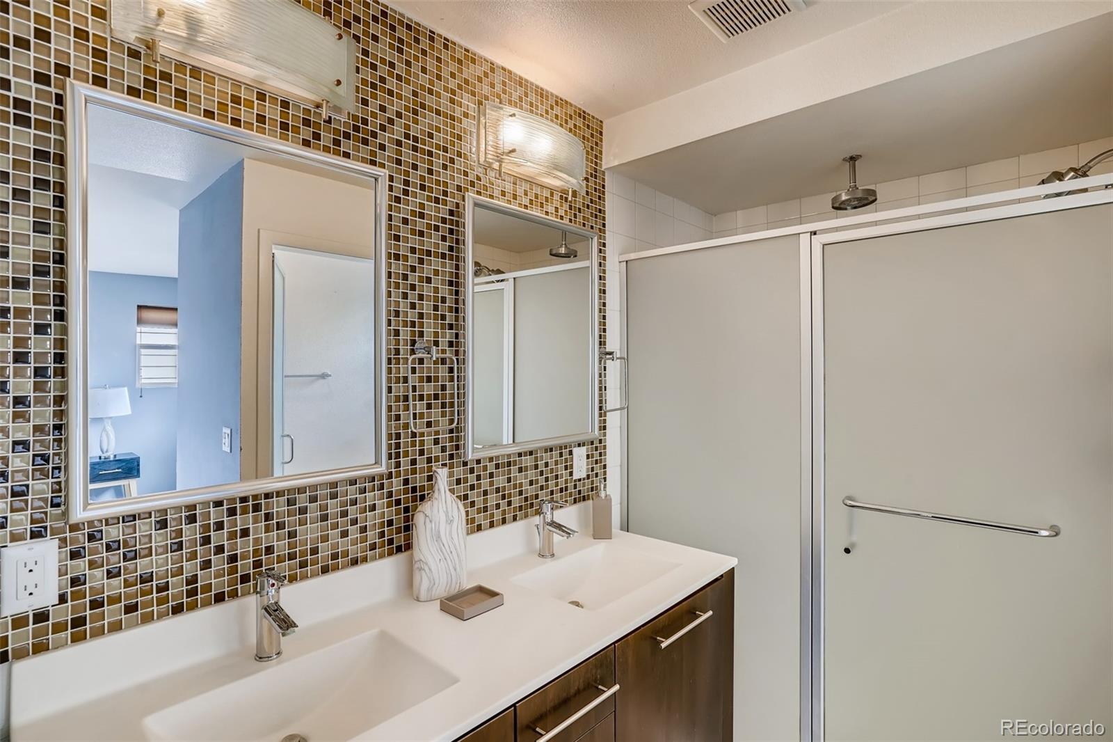 9817 Dunning Circle Highlands Ranch, CO 80126 - Photo 17 of 28 a bathroom with a sink and a mirror