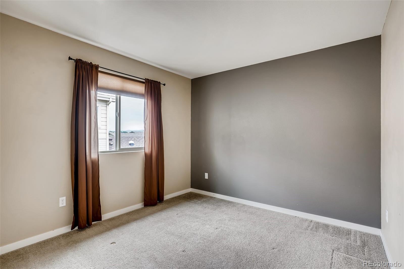 9817 Dunning Circle Highlands Ranch, CO 80126 - Photo 18 of 28 an empty room with windows