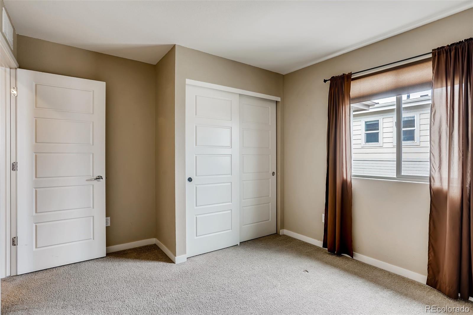 9817 Dunning Circle Highlands Ranch, CO 80126 - Photo 19 of 28 a view of an empty room with closet and a window
