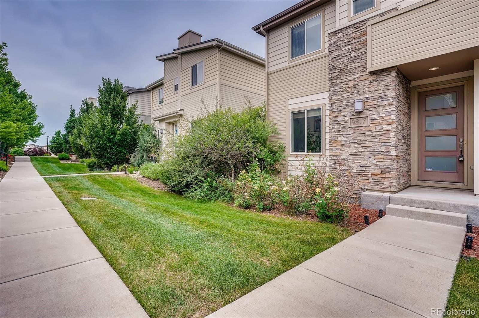 9817 Dunning Circle Highlands Ranch, CO 80126 - Photo 2 of 28 a front view of a house with a yard