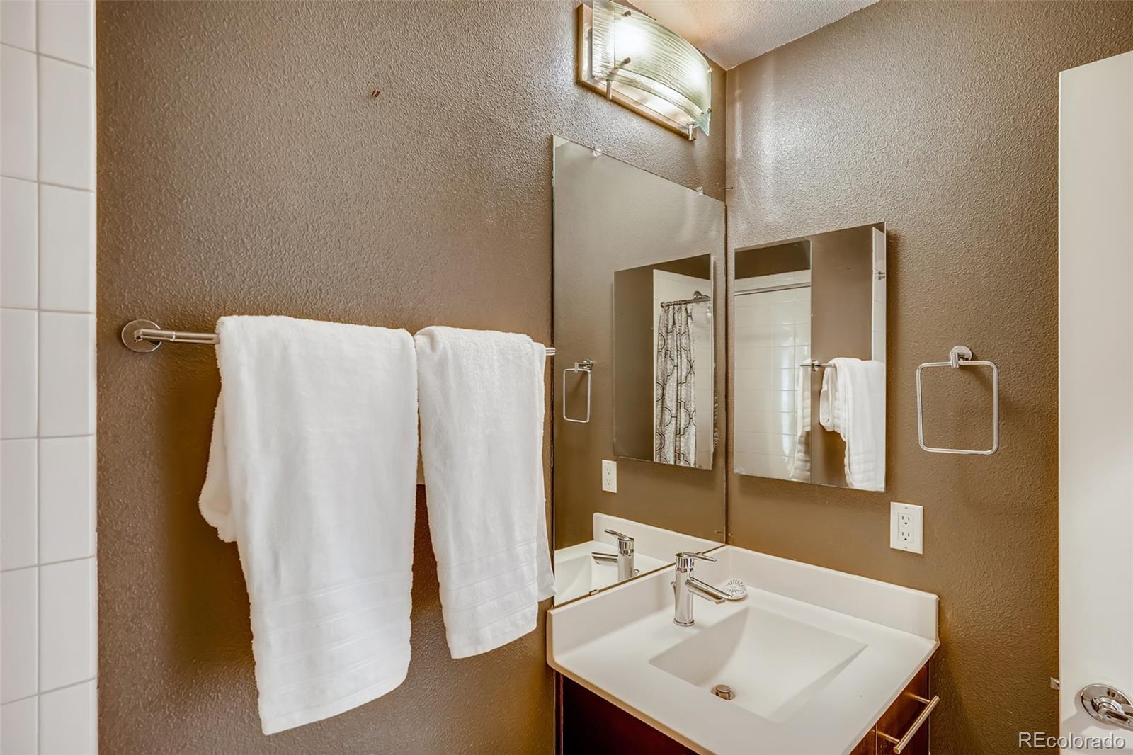 9817 Dunning Circle Highlands Ranch, CO 80126 - Photo 22 of 28 a bathroom with a sink and mirror
