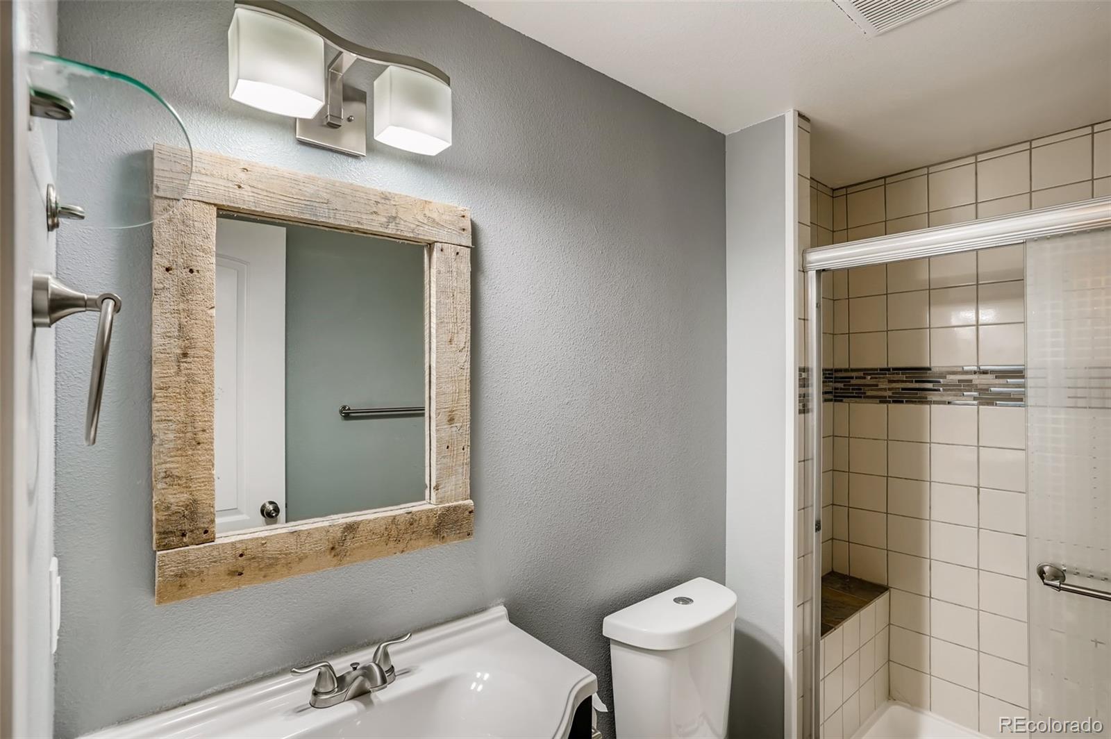 9817 Dunning Circle Highlands Ranch, CO 80126 - Photo 23 of 28 a bathroom with a sink and a mirror