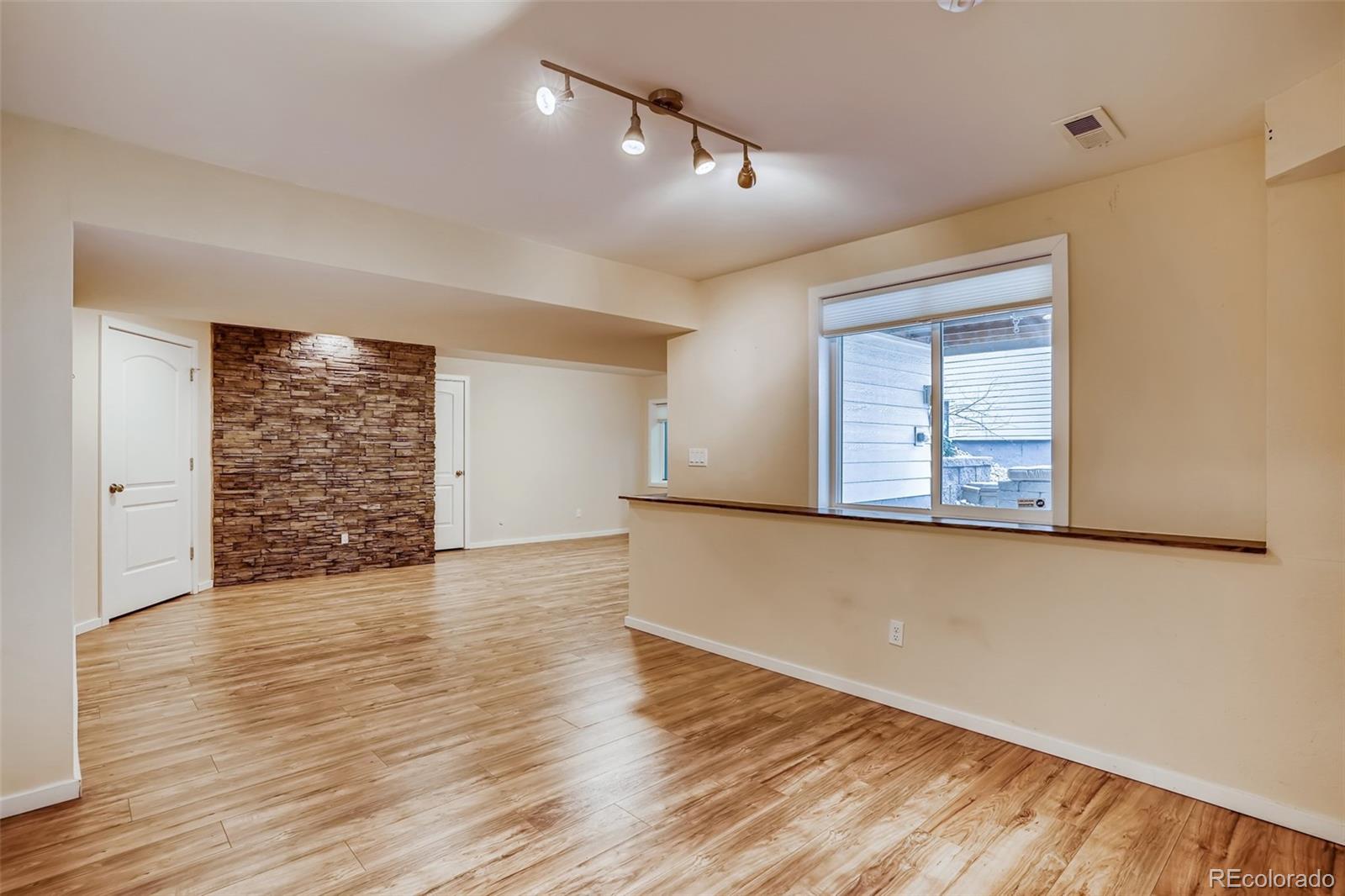 9817 Dunning Circle Highlands Ranch, CO 80126 - Photo 24 of 28 an empty room with wooden floor and windows