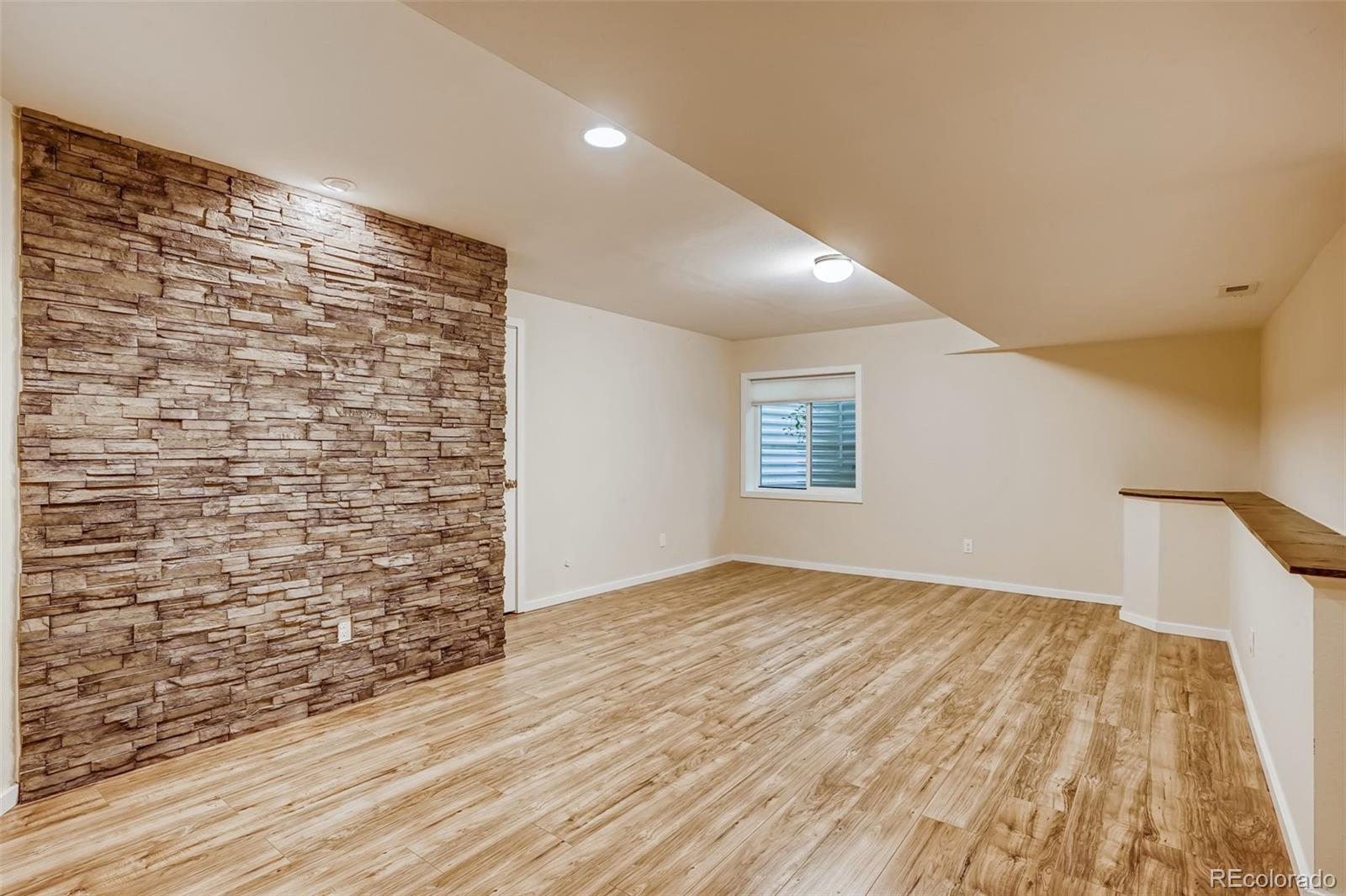 9817 Dunning Circle Highlands Ranch, CO 80126 - Photo 25 of 28 a view of an empty room and wooden floor