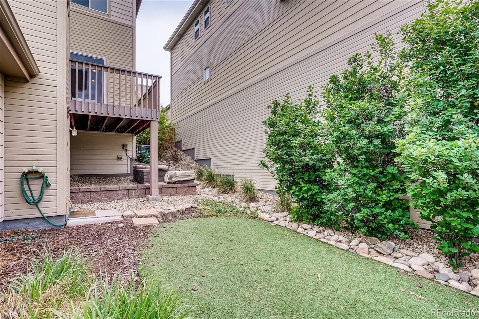 9817 Dunning Circle Highlands Ranch, CO 80126 - Photo 28 of 28 a backyard of a house with table and chairs