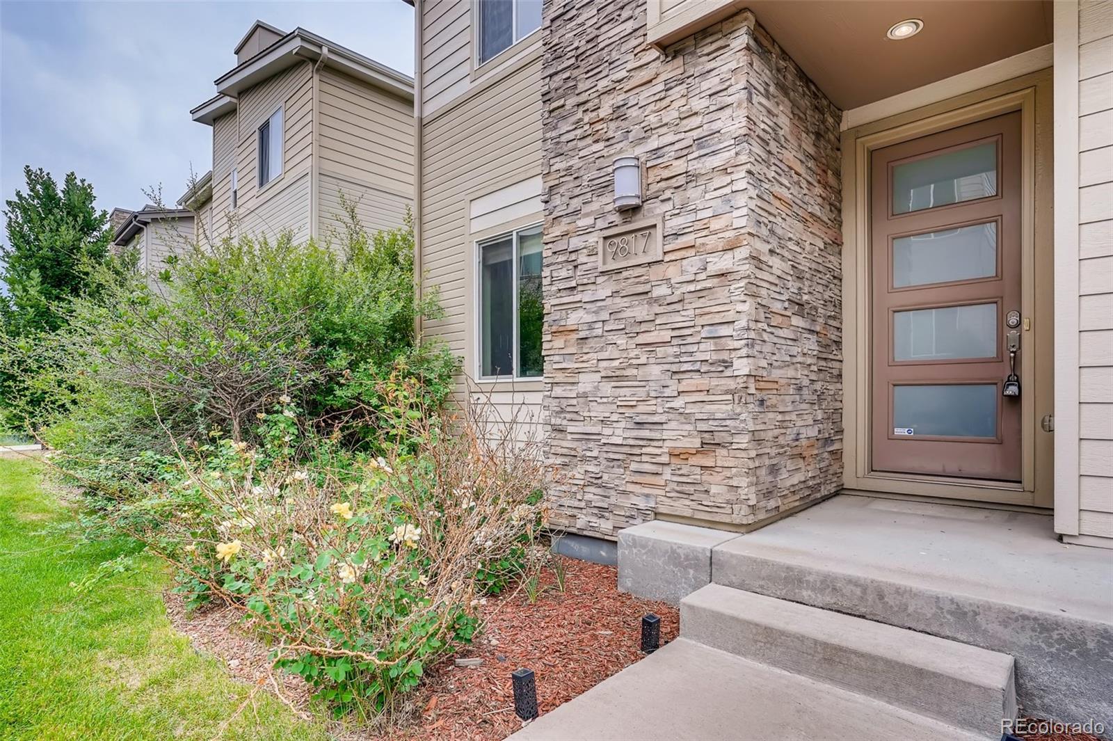 9817 Dunning Circle Highlands Ranch, CO 80126 - Photo 3 of 28 a view of house with outdoor space
