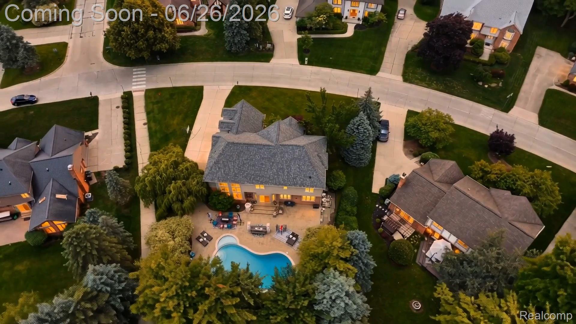 2619 Lambeth Park Rochester, MI 48306 - Photo 55 of 71 Expansive residential property featuring a large inground swimming pool, a multi-level patio, mature landscaping, and a spacious driveway