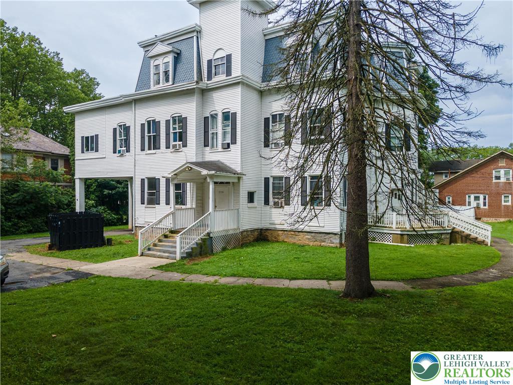228 North 14th Street Easton, PA 18042 - Photo 1 of 12 a front view of a house with a garden and trees
