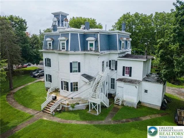 a aerial view of a house with a yard