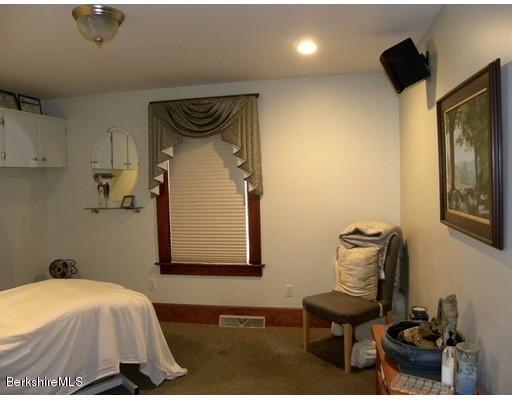 335 Federal Street Greenfield, MA 01301 - Photo 12 of 30 a bedroom with a bed and a mirror