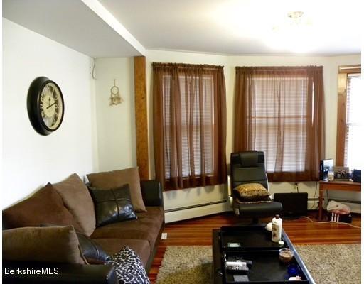 335 Federal Street Greenfield, MA 01301 - Photo 17 of 30 a living room with furniture and a floor to ceiling window