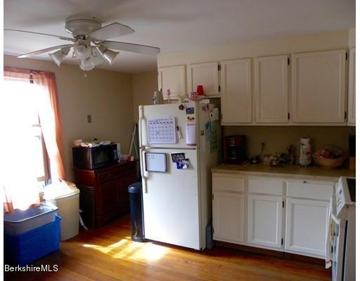 335 Federal Street Greenfield, MA 01301 - Photo 18 of 30 a kitchen with refrigerator and cabinets