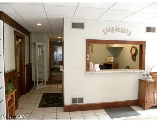 335 Federal Street Greenfield, MA 01301 - Photo 3 of 30 a view of a hallway with wooden floor and furniture