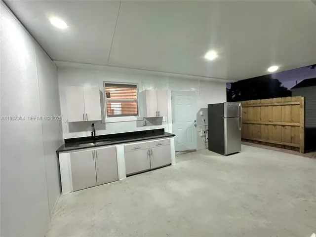 a kitchen with refrigerator and microwave