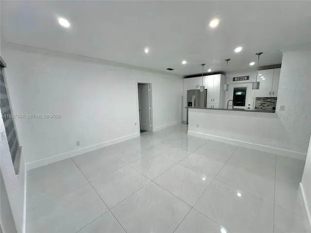 an empty room with kitchen and appliances