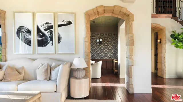 a living room with furniture and a painting on the wall