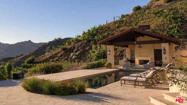 a view of a terrace with a couch and a fireplace